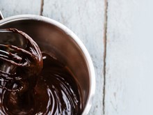 A bowl of melted chocolate, teased by a whisk